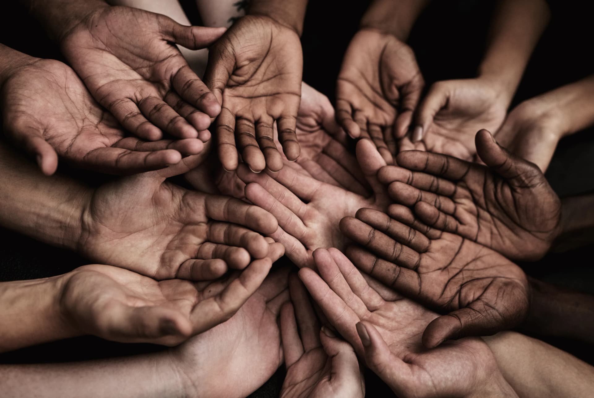 Many hands reaching into a circle