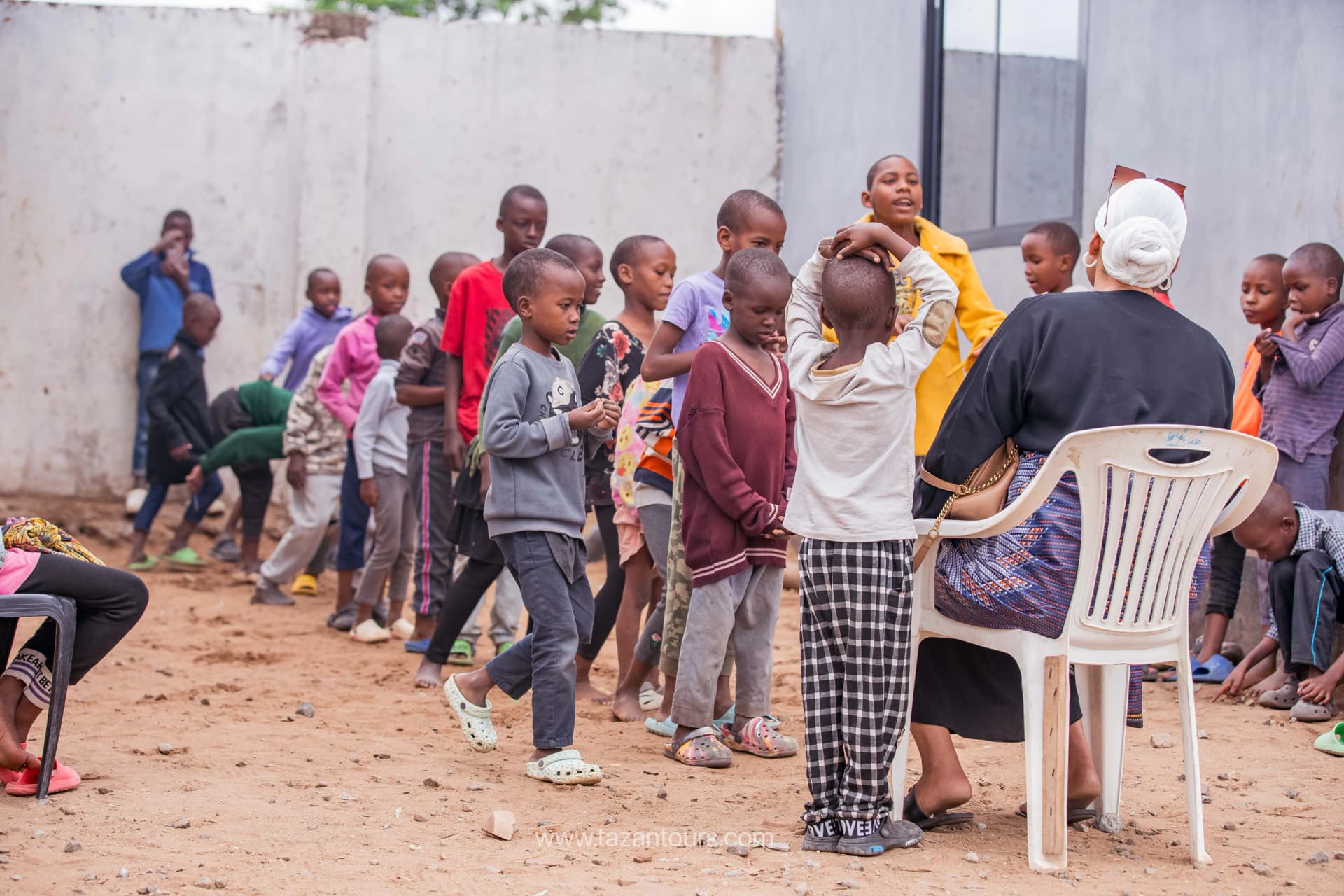 Children playing games with volunteers at a Tazan Foundation community day