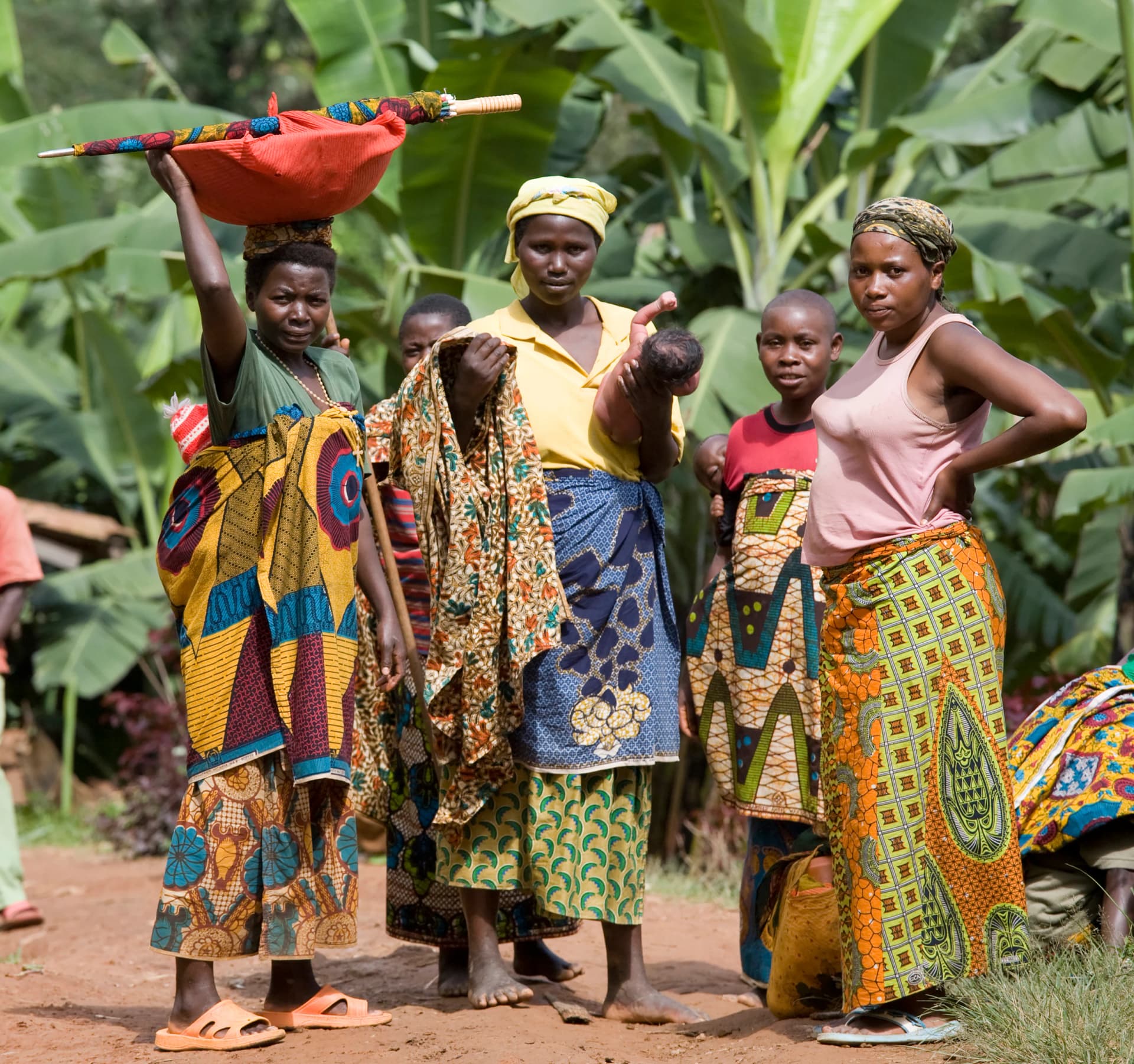 Women and children standing together in a village